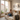 Frau entspannt mit Handy und Kaffee auf dem Sofa, Altbau-Wohnung mit Balkon und Stadtblick